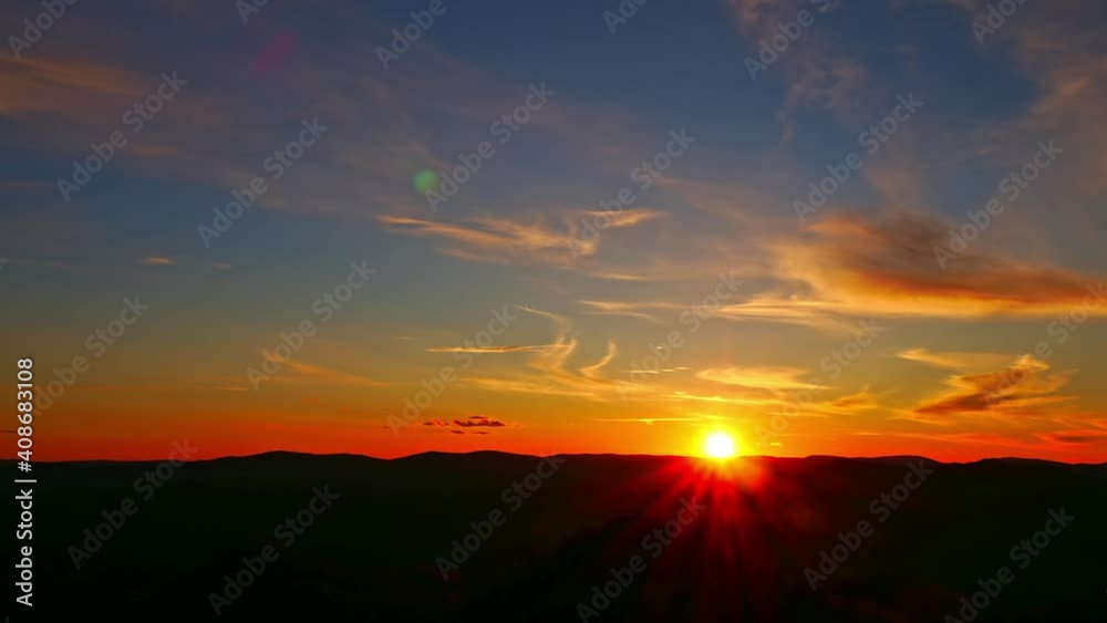 Time-lapse of sunset, dramatic sky and silhouette of mountains Time-lapse of sunset, dramatic sky and silhouette of mountains