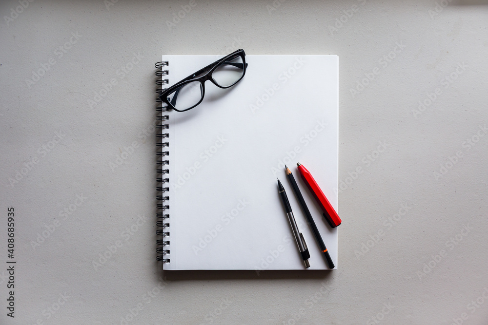 Notebook with glasses and art supplies Notebook with glasses and art supplies
