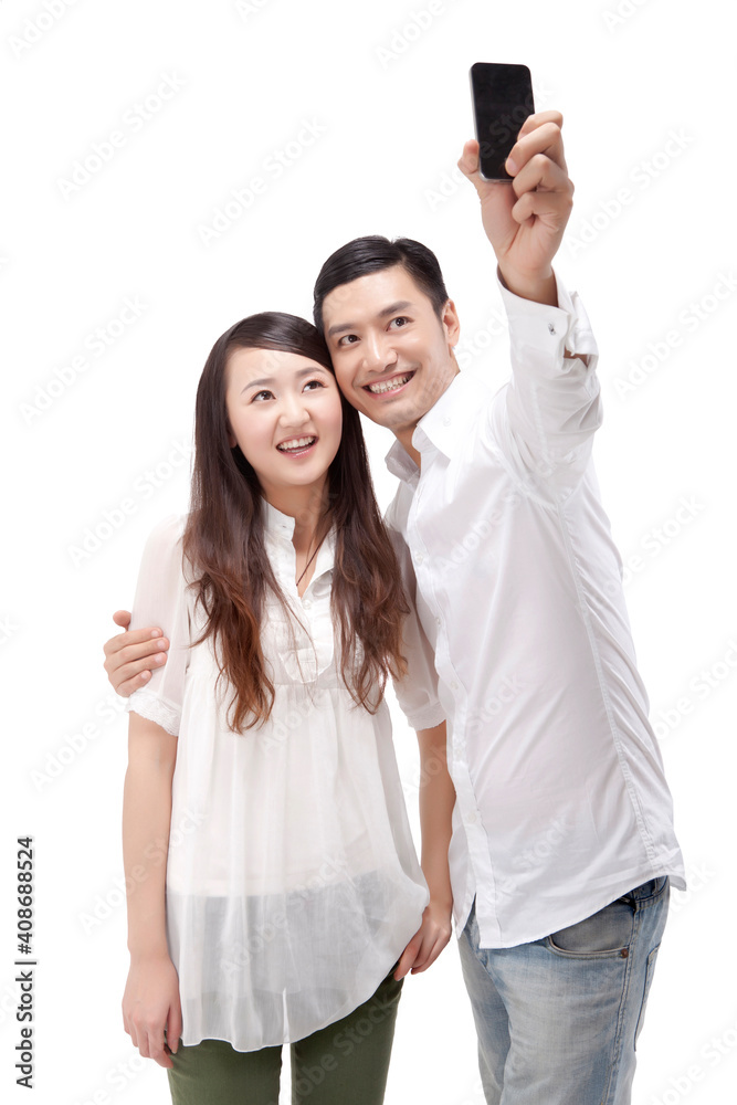 Oriental fashion young couple using mobile phone self-timer Oriental fashion young couple using mobile phone self-timer