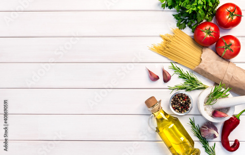 Fresh organic ingridients, pasta spaghetti of italian recipes. Healthy food concept on white wooden table background. Top view, copy space