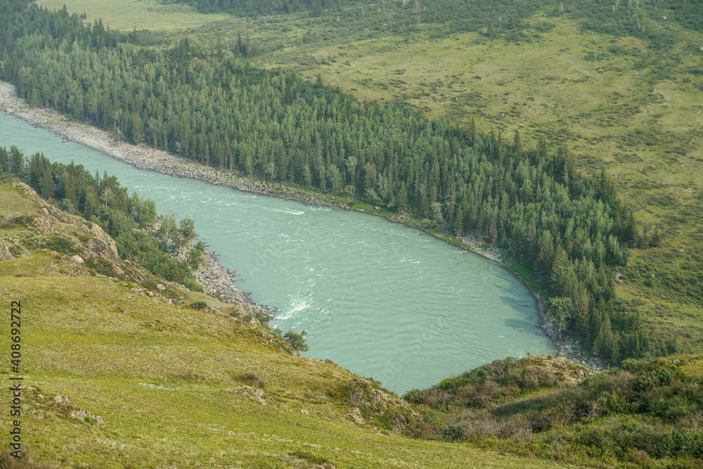 Beautiful aerial view from above to wide mountain river. Scenic view from top to big turquoise river in mountains. Vivid sunny landscape with wide turquoise river and green hills and rocks with trees. Beautiful aerial view from above to wide mountain river. Scenic view from top to big turquoise river in mountains. Vivid sunny landscape with wide turquoise river and green hills and rocks with trees.