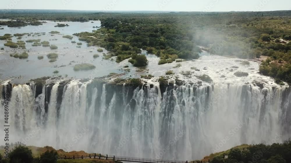 The Victoria Falls at the Border of Zimbabwe and Zambia in Africa. The Great Victoria Falls One of the Most Beautiful Wonders of the World. Aerial Shot From Above. Camera Moves Forward The Victoria Falls at the Border of Zimbabwe and Zambia in Africa. The Great Victoria Falls One of the Most Beautiful Wonders of the World. Aerial Shot From Above. Camera Moves Forward