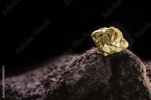 pure gold ore found in the mine, dark background.