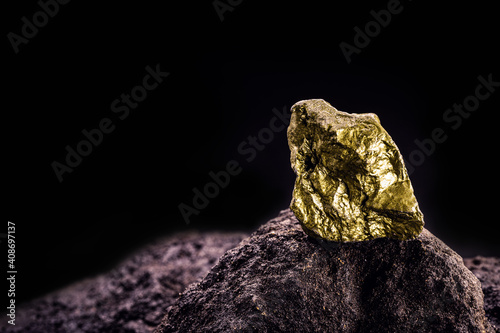 gold nugget on stone, gold inside cave, concept of rarity and luxury