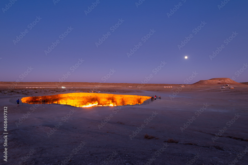 Darvaza Gas Crater in Derweze, Turkmenistan, part of Karakum Desert during twilight. Also know as Darwaza Gates to Hell or Door to Hell.