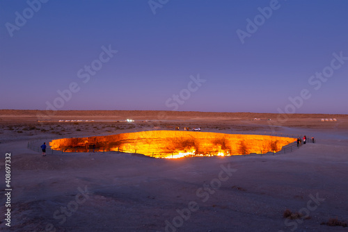 Darvaza Gas Crater in Turkmenistan, part of Karakum Desert during twilight. Also know as Gates to Hell or Door to Hell. Natural gas burning. photo