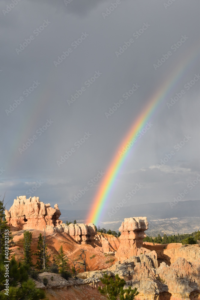A magnificent rainbow arches over Bryce Canyon National Park in Utah at sunset.