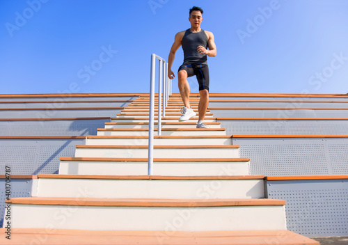 young man running downstairs at stadium