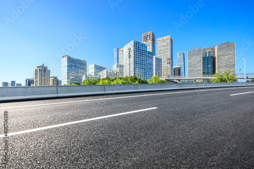 Asphalt road and modern city commercial buildings in Beijing China.