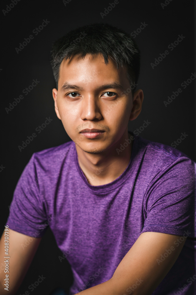 Fototapeta premium a young man close up portrait, on black background