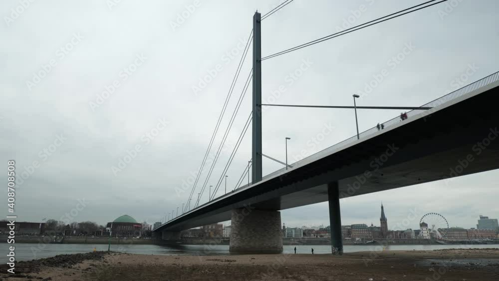 Timelapse of river Rhein bridge in city of Düsseldorf, Germany with the famous Tonhalle and the old town in the Background on a dull day Timelapse of river Rhein bridge in city of Düsseldorf, Germany with the famous Tonhalle and the old town in the Background on a dull day