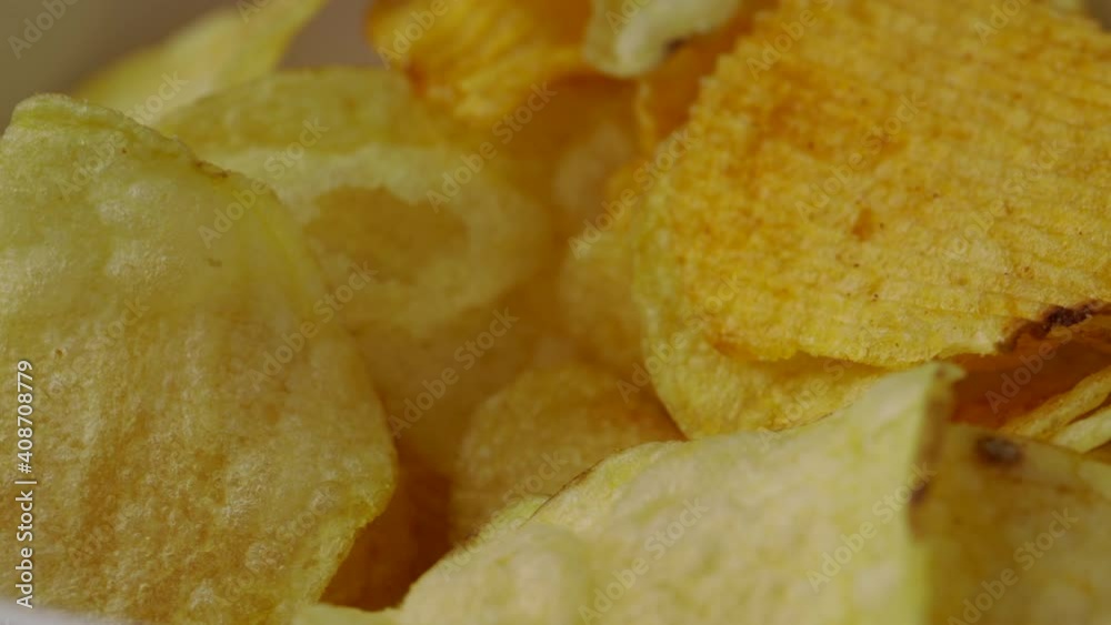 Close up snack food crispy potato chip salty rotates slowly. Fast food or junk food snacks unhealthy concept. Close up snack food crispy potato chip salty rotates slowly. Fast food or junk food snacks unhealthy concept.