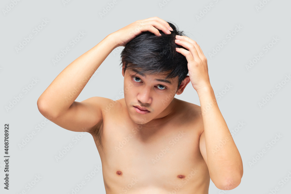 Young man was checking the health of his hair and scalp. Young man was checking the health of his hair and scalp.