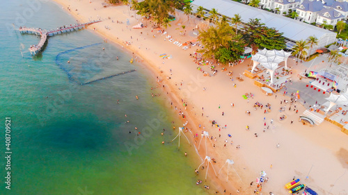 Aerial view of Sunset in Phu Quoc beach with nice view. Tourists, sunbeds and umbrellas on beautiful day in Sanato beach, Phu Quoc island, Vietnam photo