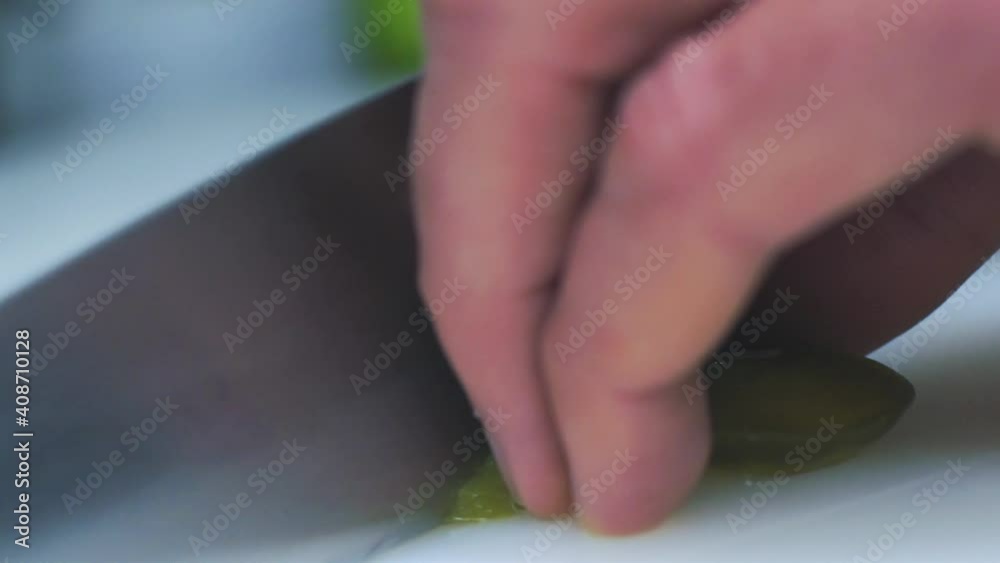 Chopping the pickled hot jalapeno peppers. Close-up Chopping the pickled hot jalapeno peppers. Close-up