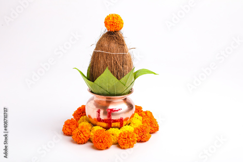 Indian festival akshaya tritiya concept : Decorative kalash with coconut and leaf with floral decoration photo