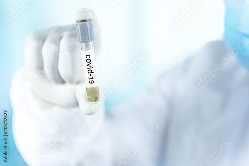 close up a test tube in the hand of a doctor from the scientific laboratory, a concept of drug use to treat and protect the global COVID-19 pandemic
