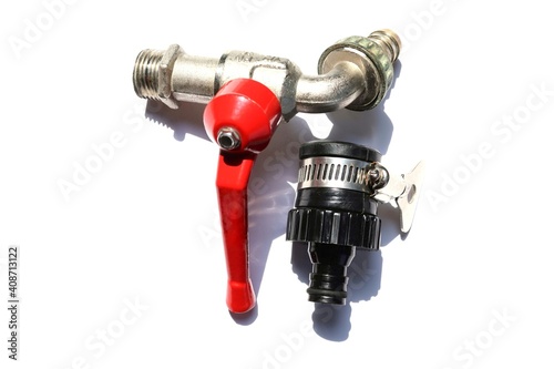 Quick water faucet tap connector black and metal faucet red handle with shadow isolated on white background closeup. 