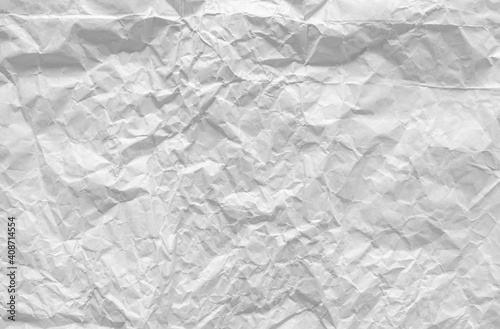 Top view of crumpled white paper for the background. Light and soft color background  large crumpled paper background texture for art design. The surface is not smooth but attractive.