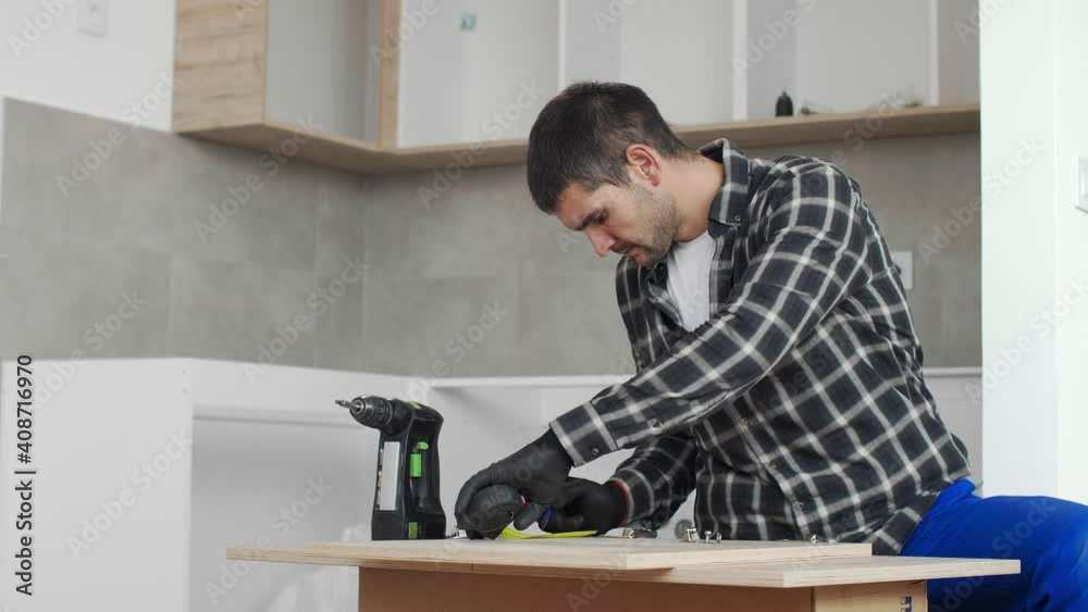 Carpenter measuring shelves that are parts of new kitchen with meter. Carpenter measuring shelves that are parts of new kitchen with meter.