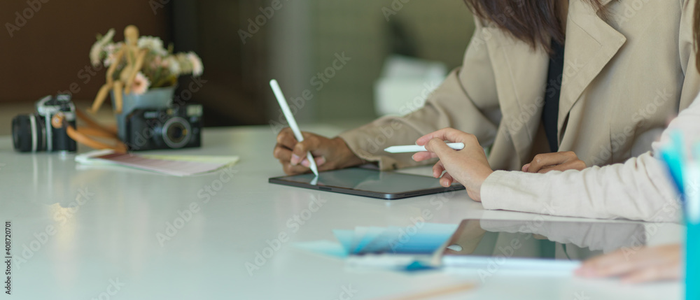 Businesspeople hands working with digital tablet and office supplies Businesspeople hands working with digital tablet and office supplies