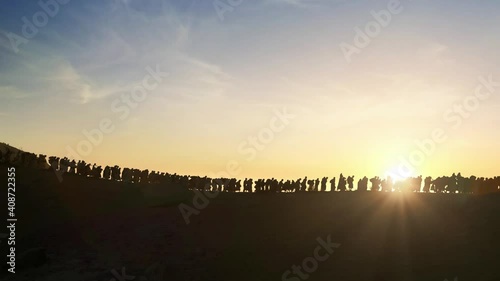 The Jews being expelled and going into exile all over the world in the Middle Ages., silhouette of Israelis walking in the sunset photo