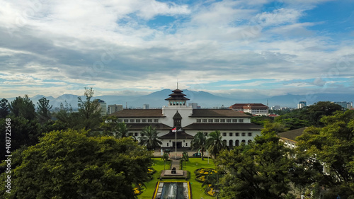 Aerial view of Gedung Sate, Bandung, West Java, Indonesia with beautiful sky and green landscape. Old Historical building with art decoration style, Governor Office, icon and landmark of Bandung city. photo