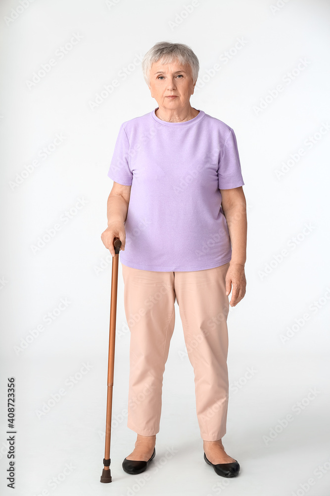 Senior woman with walking stick on white background Senior woman with walking stick on white background