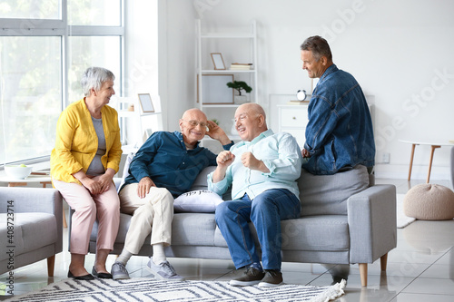 Senior people sitting on so...