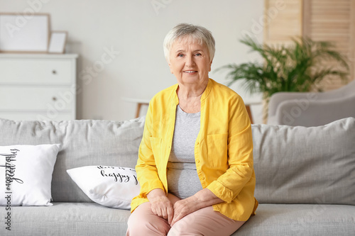 Senior woman sitting on sof...