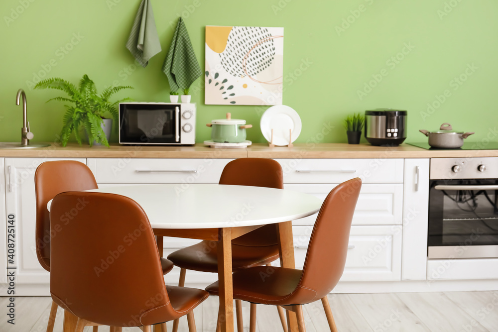 Fototapeta premium Dinning table in interior of modern kitchen