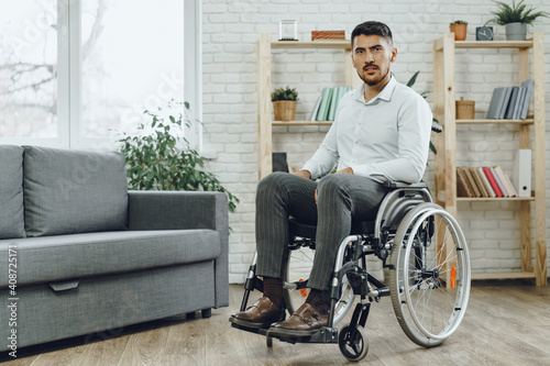 Portrait of disabled man in formal wear sitting in a wheelchair