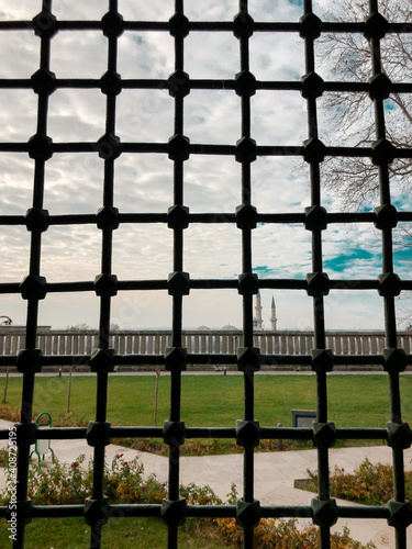 Black bars and sky in historical building. Feelings of imprisonment, confinement and bondage. Longing for freedom.
