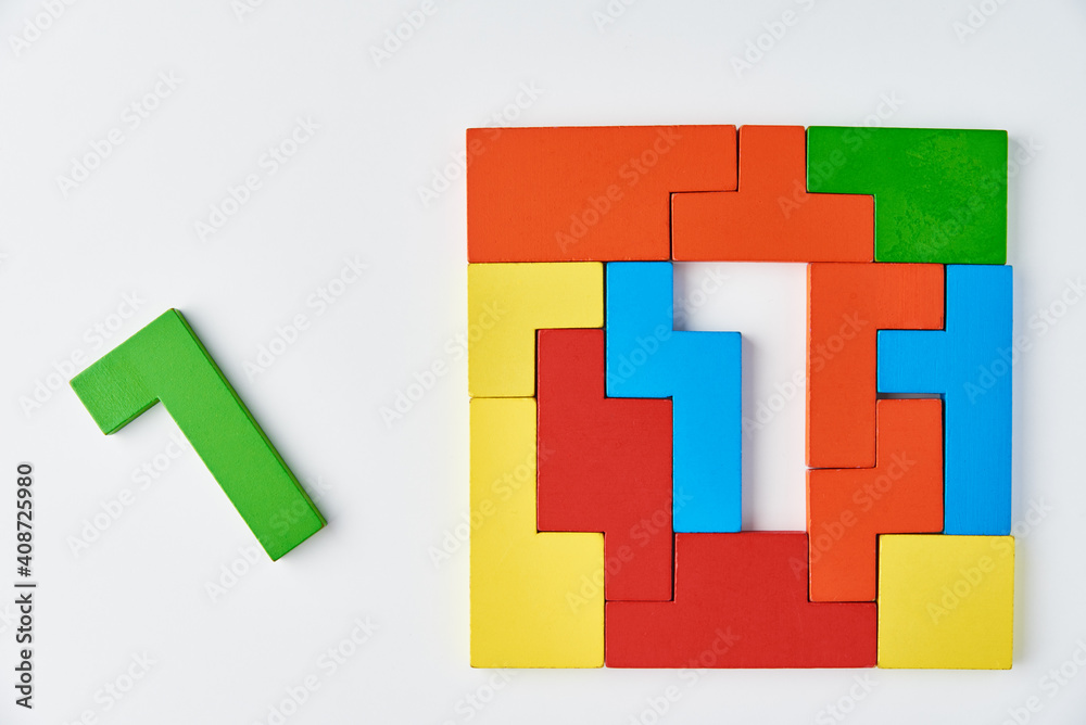 Obraz premium Logical thinking and finishing task concept. Different shapes colorful wooden blocks on white background