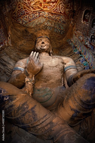 Low angle view of a Buddha statue in a cave, Yungang Buddhist Caves, Datong, China photo