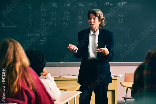 Female professor giving lecture to the university class
