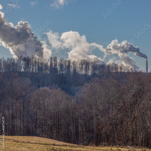 Smokestack emissions from coal fired powerplants photographed against a rural West Virginia backdrop photo