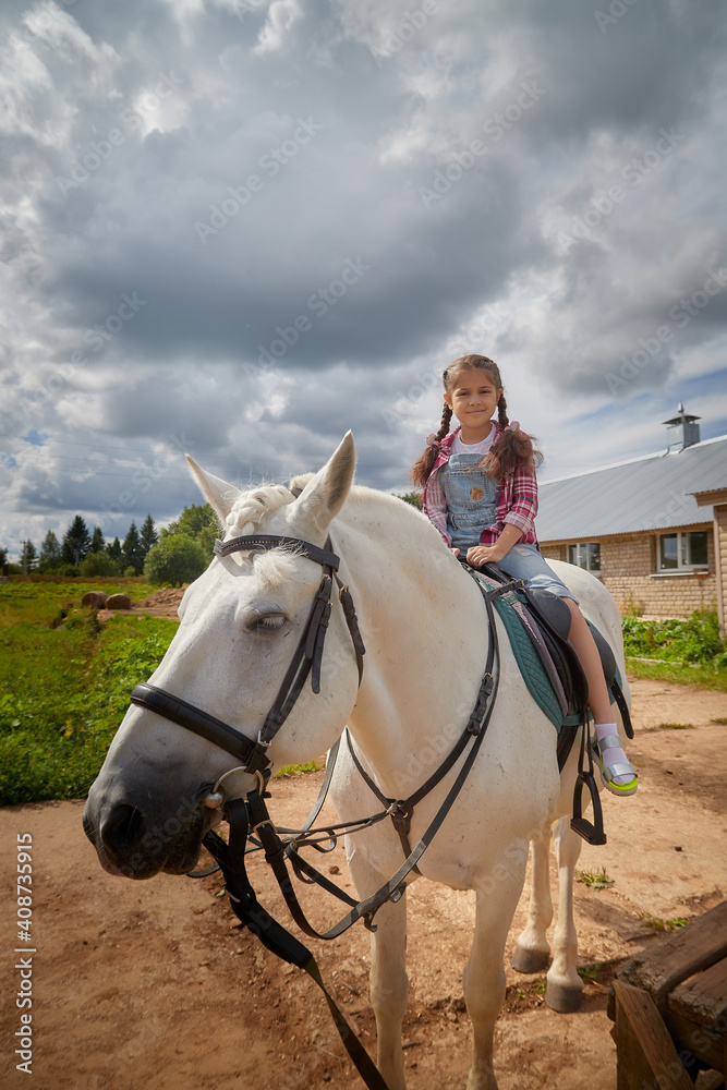 A teenage girl and a horse in nature among green trees A teenage girl and a horse in nature among green trees