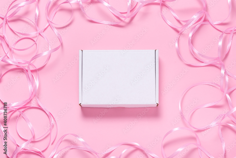 White Carton box decorated with pink ribbon