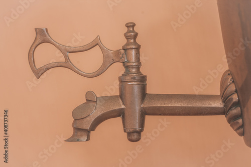Vintage copper faucet. Vintage faucet on a copper samovar close up