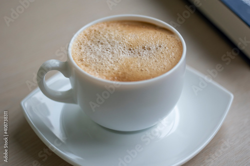 Cup of Morning cappuccino coffee with milk and blue book photography © vector_master