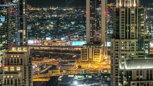 Aerial top view of Sheikh Zayed road timelapse with night traffic, metroline and illuminated skyscrapers. This is one of the iconic views of Dubai, UAE photo