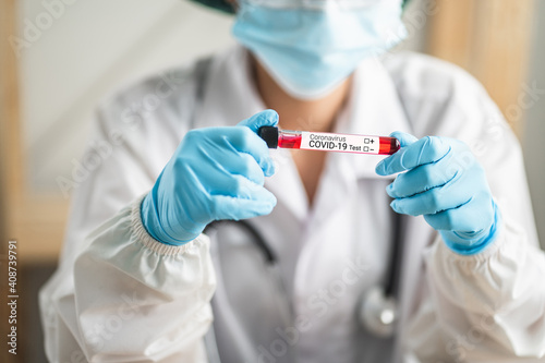 Close up, Doctor or scientist holding blood test tube coronavirus(COVID-19) in laboratory room