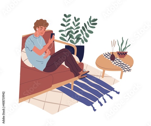 Guy sitting on sofa with phone and surfing internet. Young man watching funny...
