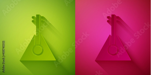 Paper cut Musical instrument balalaika icon isolated on green and pink background. Paper art style. Vector.