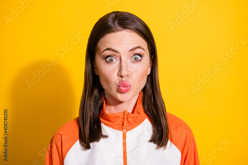Photo of pretty surprised young woman look amazed pouted lips isolated on bright yellow color background