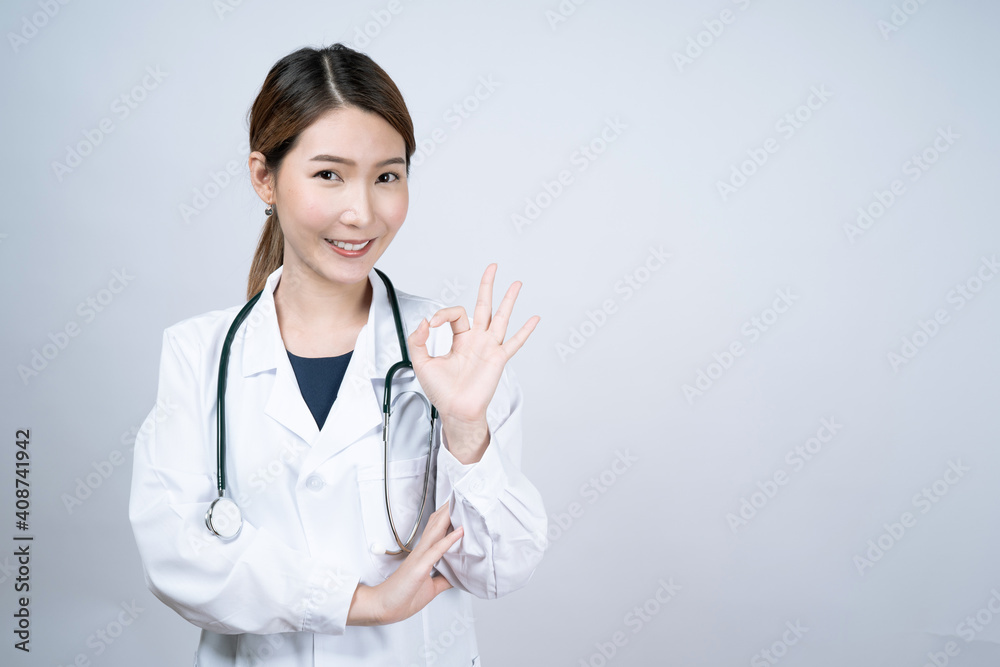 Portrait of Asian woman doctor wearing uniform stand isolated on white studio background. Portrait of Asian woman doctor wearing uniform stand isolated on white studio background.