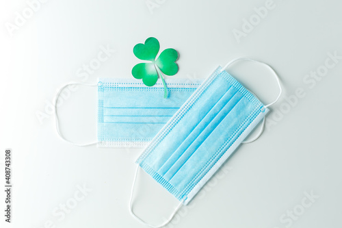 Blue protective face mask on a green background. March 17, happy saint patricks day Coronavirus concept Pandemic quarantine photo