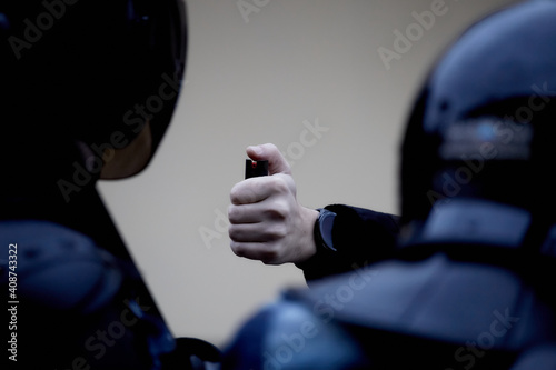 A protester attacks a National Guard soldier with a gas canister photo