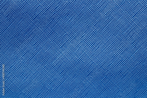 Seamless plastic texture background. Close-up of a detail from a blue surface of a cosmetic bag. Beautiful backdrop. Macro.